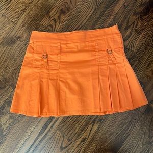 Orange pleated mini skirt